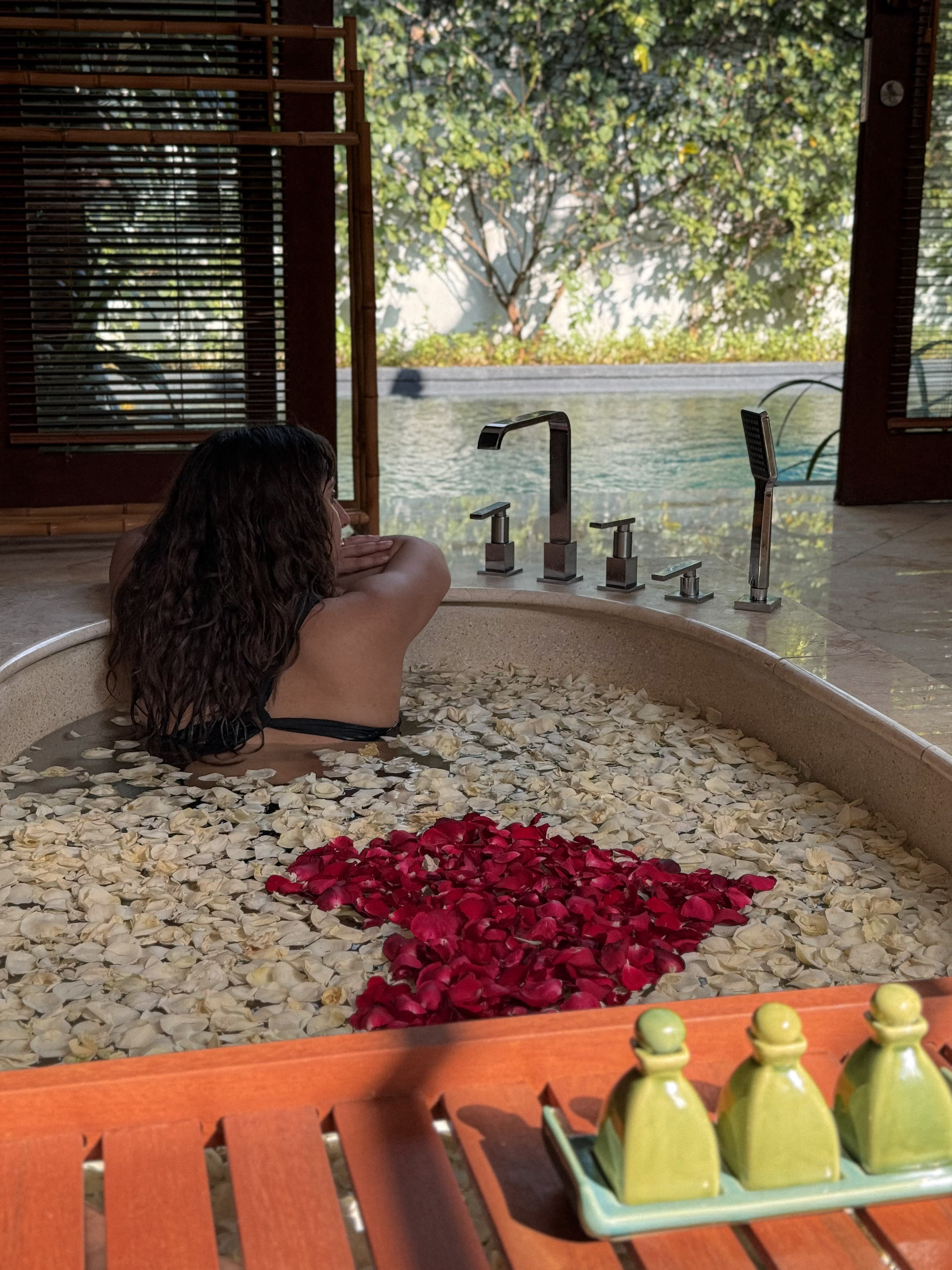 Infinity bathtub overlooking private pool - premium amenity that supports luxury positioning and justifies 40% higher room rates