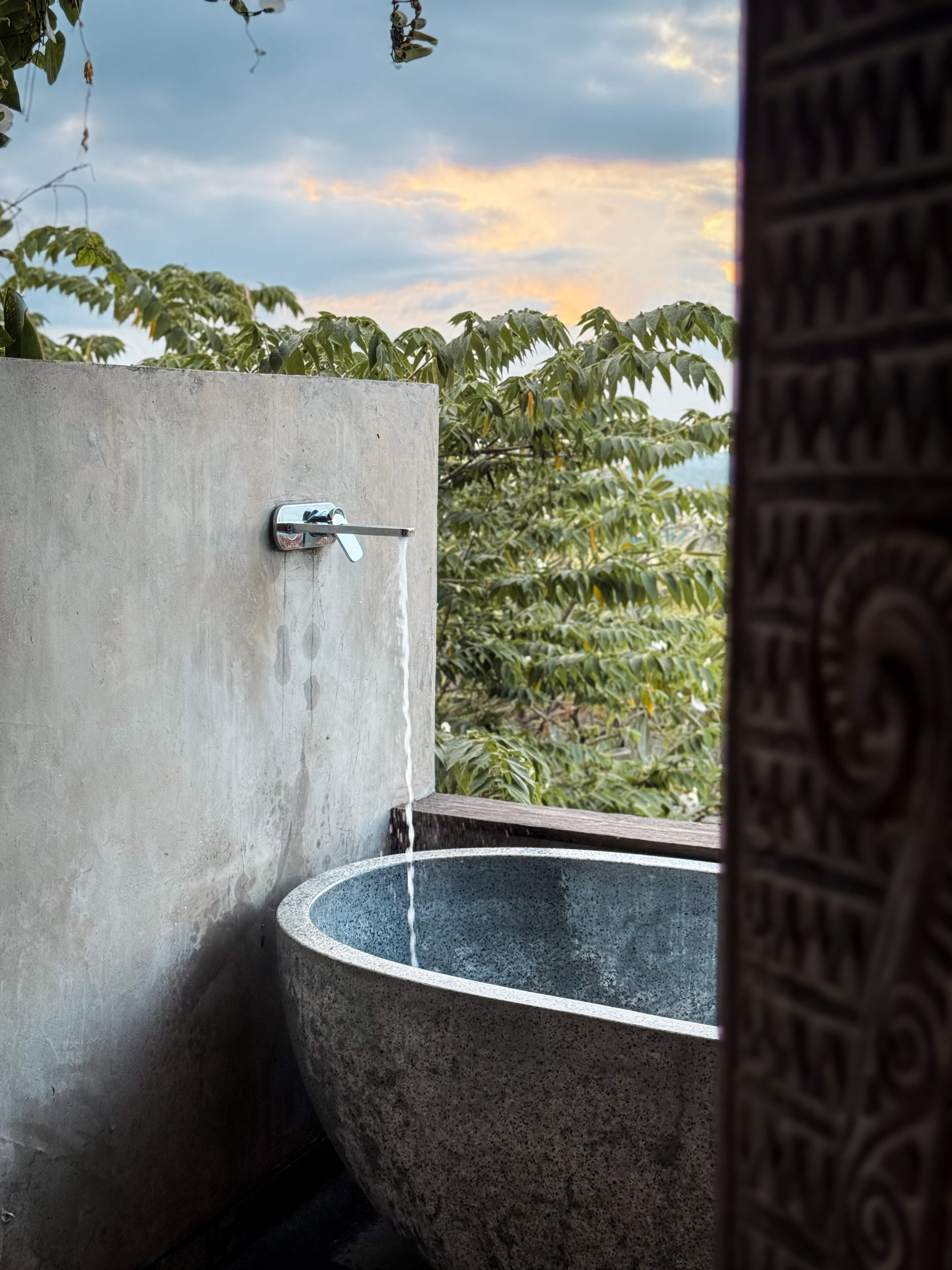 Luxury spa bathtub with natural stone design - wellness amenity that drives premium room upgrades